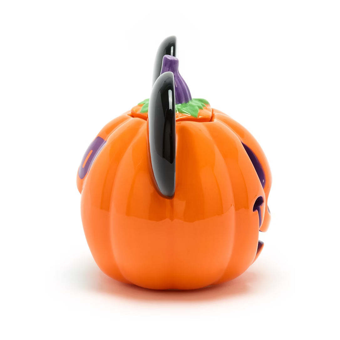 Pumpkin-shaped container with a black lid on a white background