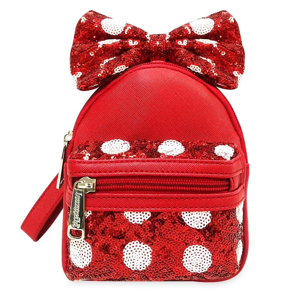 Red backpack with white polka dots and a large bow on a white background